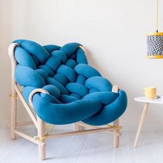 a blue couch sitting on top of a wooden frame