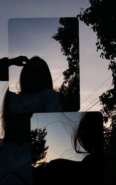 the silhouette of a woman with her hair blowing in the wind and trees behind her