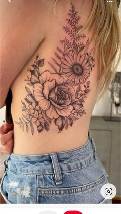 a woman's back with flowers and leaves on it