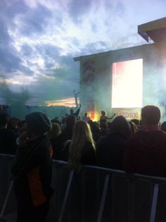 a large group of people standing in front of a stage