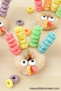 donuts decorated like turkeys with candy eyes and rainbow doughnuts on sticks