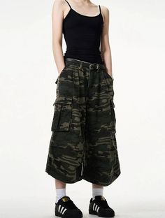 Embrace a fierce combination of style and practicality with our Camo Bermuda Capri Cargo Shorts. These high-waisted shorts feature a classic camouflage print, expertly crafted from a durable blend of materials for lasting comfort. The loose fit promotes freedom of movement while the integrated belt adds a functional, fashionable touch. Pair with a simple tee and sneakers for a laid-back look, or dress them up with a sleek blouse and ankle boots for a more sophisticated angle. Perfect for a varie High Waist Utility Shorts For Streetwear, High Waist Bottoms With Built-in Shorts For Streetwear, Combat Wide Leg Bottoms For Streetwear, Military Style Khaki Shorts, Sporty Camouflage Bottoms With Pockets, Summer Streetwear Cargo Pants With Belt Loops, Streetwear Hip-length Bottoms With Pockets, Khaki Military Style Shorts, Military Style Khaki Short Pants