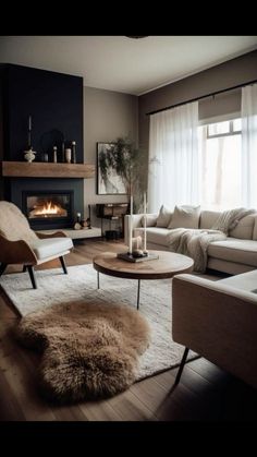 a living room filled with furniture and a fire place in the middle of the room