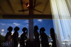 a group of people standing in front of a window with the sun shining down on them