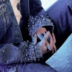 a close up of a person's feet with blue nail polish and ring on their fingers