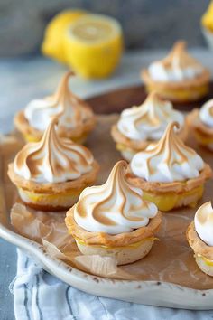 small lemon meringue tarts on a plate