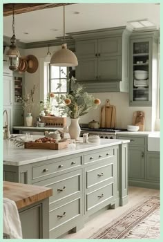 a kitchen filled with lots of green cabinets