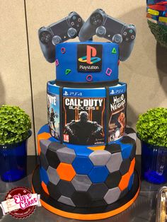 a multi - tiered cake with video game covers on it's top and sides