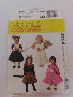 an image of children's costumes on the cover of a sewing pattern for dolls