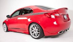 the rear end of a red car on a white background