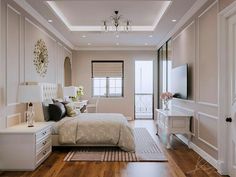 a bedroom with white walls and wood flooring has a chandelier hanging from the ceiling