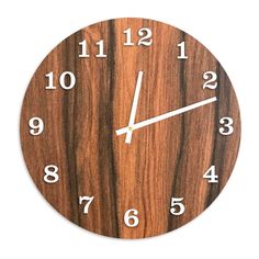 a wooden clock with white numbers on it