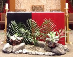 an altar with plants and rocks in front of it