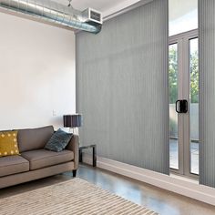 a living room with a couch and sliding glass doors