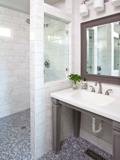 a bathroom with two sinks and a large mirror