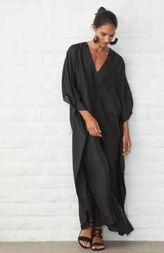 Placket Long Caftan - Women's V Neck Silk Dress – ocean+main Chic Flowy Tunic Kaftan, Chic Flowy Kaftan For Beach Cover-up, Chic Tunic Maxi Dress For Loungewear, Chic Flowy Kaftan With Kimono Sleeves, Black V-neck Kaftan For Loungewear, Chic Maxi-length Kaftan For Loungewear, Chic Maxi Length Kaftan For Loungewear, Chic Long Kaftan For Beach Cover-up, Oversized Tunic With Kimono Sleeves For Beach Cover-up