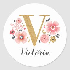 a round sticker with the letter v in gold and pink flowers on white background