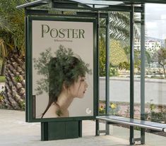 a bus stop with a poster on the side and a bench in front of it