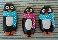 three penguins with scarves and scarfs painted on them