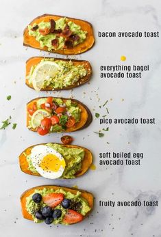 four toasted breads with avocado, bacon, and eggs on them