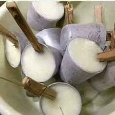 several candles are sitting in a white bowl