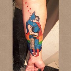 a person with a superman tattoo on their arm