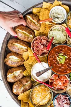 a platter filled with lots of different foods and dips on top of it