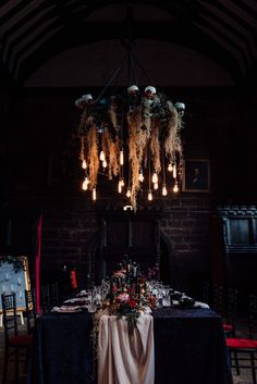 the table is set with flowers, candles and place settings for an elegant dinner party