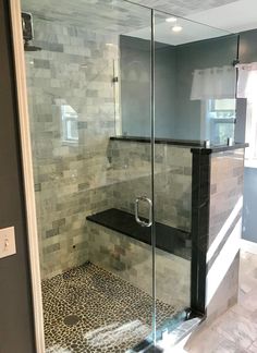 a walk in shower sitting inside of a bathroom