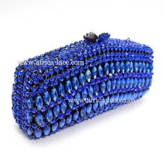 blue beaded clutch bag on white background