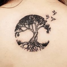 a woman with a tree tattoo on her back