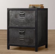 a metal filing cabinet with two drawers on the bottom and one drawer open to show books