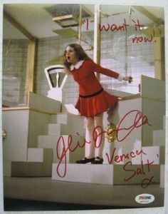 a woman in a red dress standing on top of a box