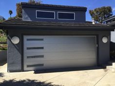 a house with a large garage door in front of it