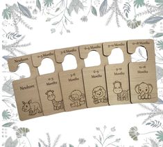 four wooden tags with animals on them and the numbers for each month in different languages