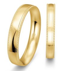 two gold wedding bands with beading on each side