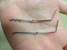 two surgical instruments are shown in the palm of someone's hand