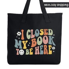 a black shopping bag with the words i closed my book to be here