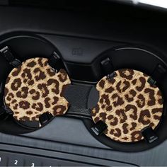 two coasters with leopard print on them sitting in the back of a car seat