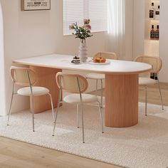 a dining table with four chairs around it