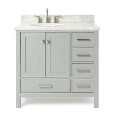 a white bathroom vanity with marble top and drawers