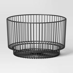 a black wire basket sitting on top of a table