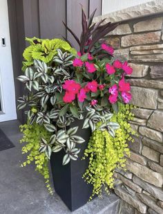 a planter filled with pink and green flowers