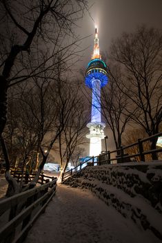 the tower is lit up in blue and white