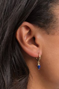 The Inlay Vessel Huggie showcases a meticulous hand-carved design, adorned with a vibrant lapis inlay. Suspended from an elaborately braided 14k gold hoop, it adds a touch of elegance to any accessory collection. Luxury Carved Blue Jewelry, Luxury Blue Carved Jewelry, Tea Container, Farmhouse Pottery, Tassel Scarf, Pamela Love, Bar Accessories, Gold Hoop, The Body Shop