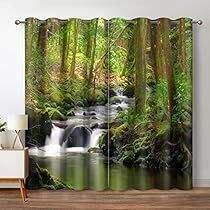 the curtains are hanging in front of a window with a view of a river and trees