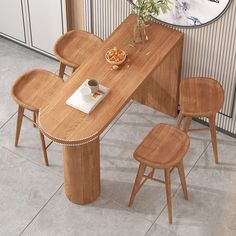 a wooden table with chairs around it and a vase on the table next to it