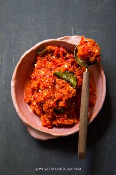 a bowl filled with food next to a spoon