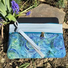 "Wallet, Clutch,or Phone case in Sky Blue Italian Leather paired with a pretty Boho Paisley Batik.This bag can carry your essentials and be your only bag-or use it in your big purse as I do for a wallet. Front zip works for change and top zip opens main section which fits dollar bills. There's also a small inside pocket that holds credit cards. Nice to carry jewelry when traveling. Or for your 7\" Knitting Needles and Crochet Hooks. 7 1/2\" wide 4 3/4\"deep PLEASE NOTE BATIK VARIES SLIGHTLY Matc Blue Zipper Pouch Clutch For Daily Use, Blue Clutch With Zipper Pouch For Daily Use, Handmade Blue Pouch Wallets, Blue Rectangular Wallet With Mobile Phone Bag, Blue Clutch Mobile Phone Bag As Gift, Blue Mobile Phone Bag Clutch As Gift, Blue Clutch With Card Slots As Gift, Blue Clutch With Card Slots For Gift, Blue Clutch For Mobile Phone As Gift