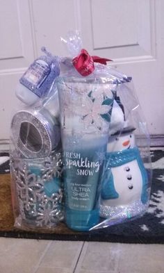 a snowman themed gift basket is sitting on the floor